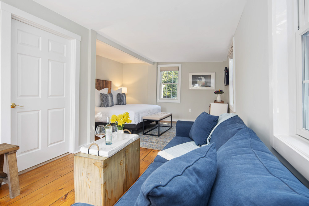 martha's vineyard hotel guest room with bed & couch, wood floors