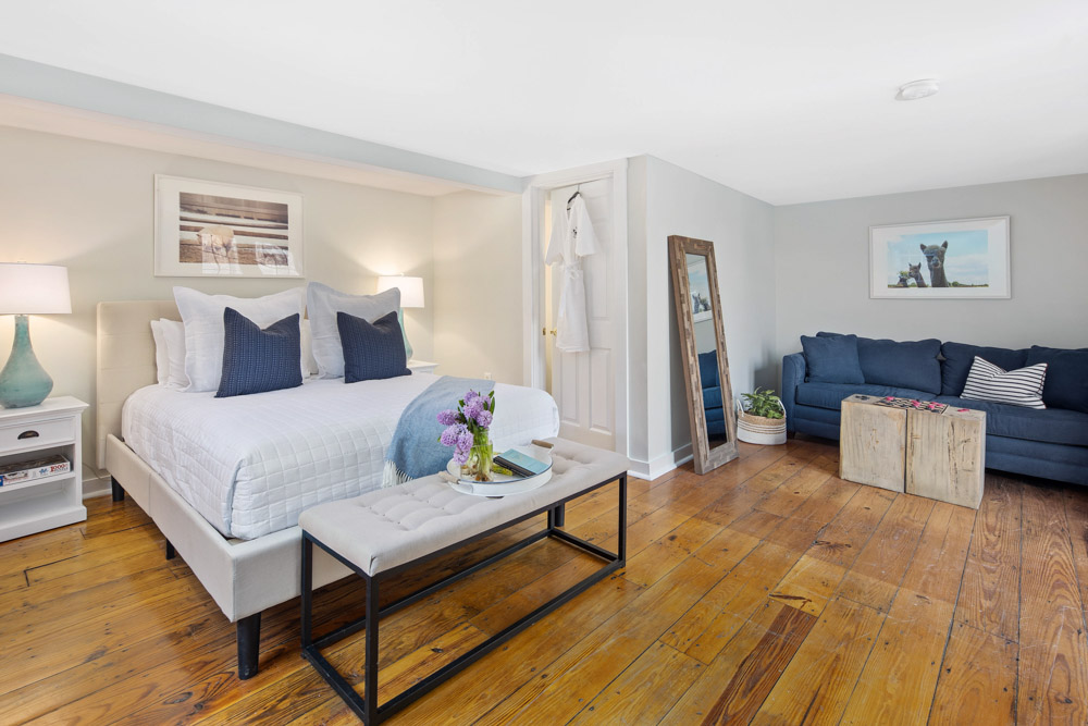 martha's vineyard hotel guest room with bed & couch, wood floors