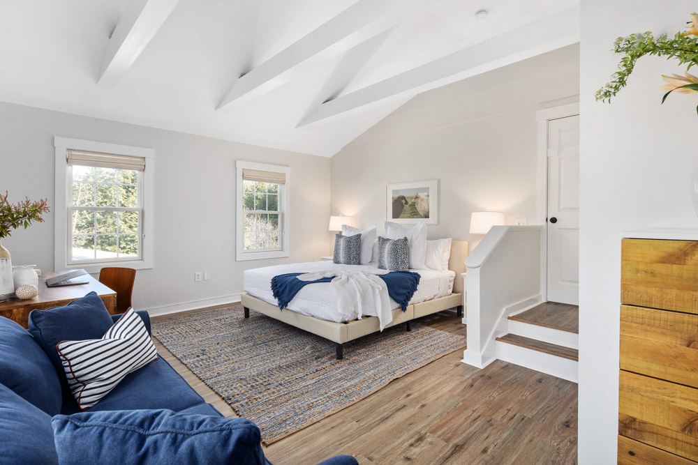 martha's vineyard hotel guest room with bed & couch, wood floors