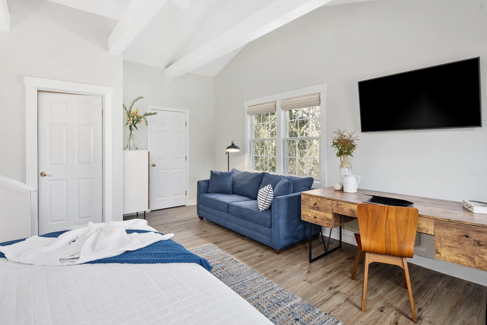 martha's vineyard hotel guest room with bed & couch, wood floors