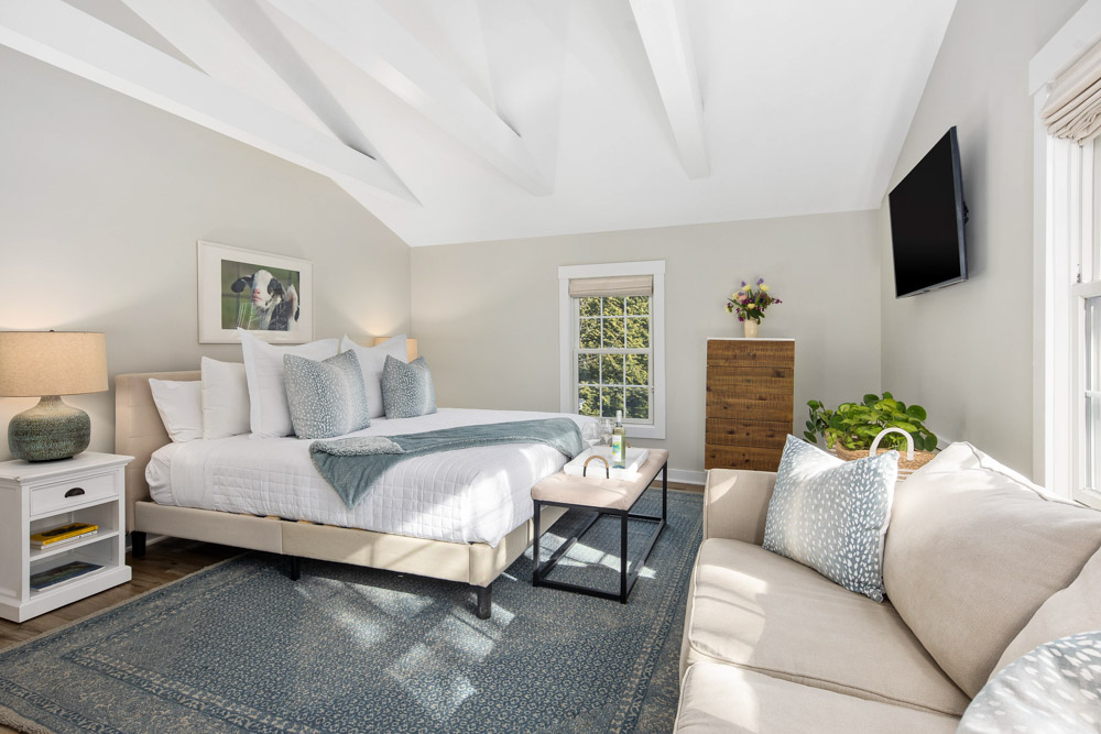 martha's vineyard hotel guest room with bed & couch, wood floors