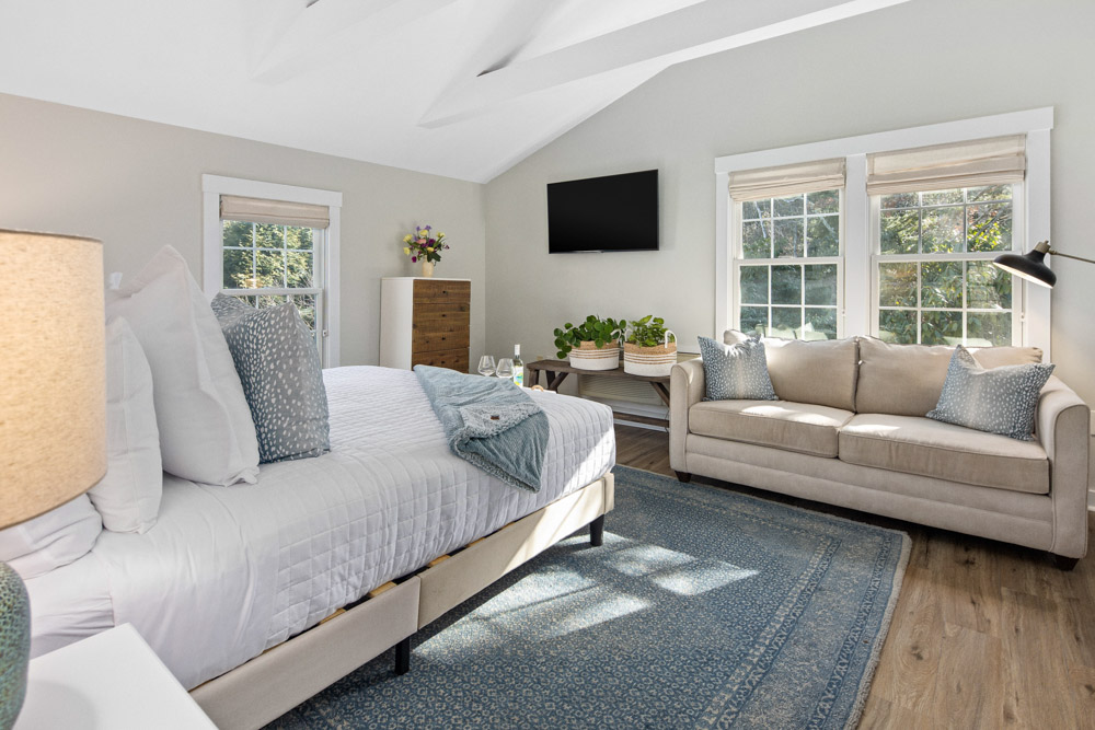 martha's vineyard hotel guest room with bed & couch, wood floors